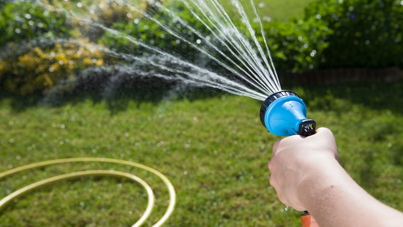 One of our team watering a customers garden