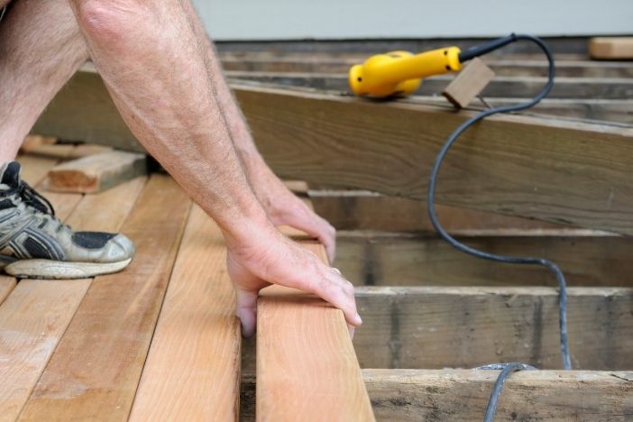 landscape gardener installing decking